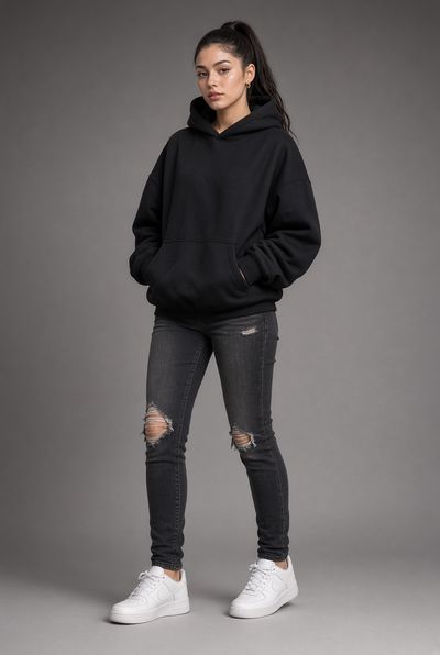 Young woman in black streetwear poses confidently in studio