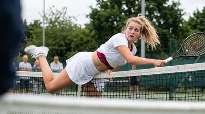 A Scandinavian tennis player falls awkwardly across the net in panic