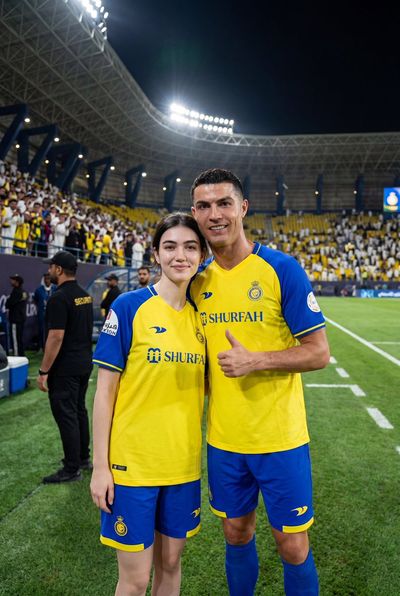 Female fan poses with Ronaldo in stadium after match