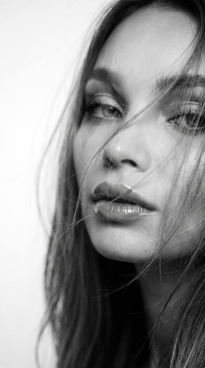 Wind-swept woman with glossy lips in dreamy double exposure