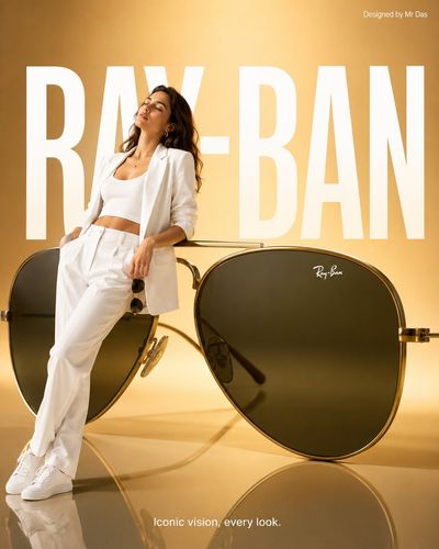 Young woman in white leans against oversized Ray-Ban aviators