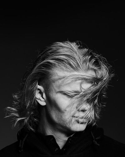 Platinum-haired football star glares intensely in monochrome editorial portrait