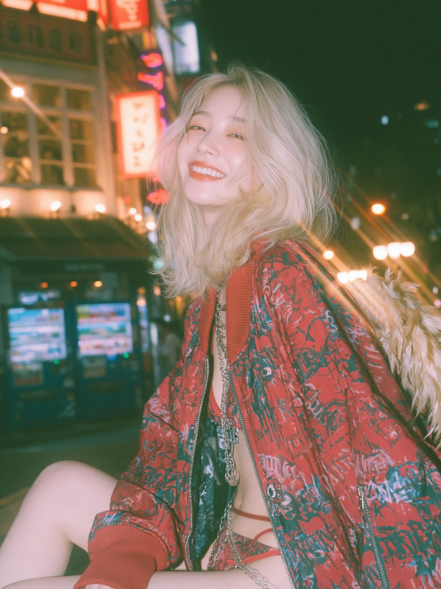 Japanese woman laughs in red bomber jacket with angel wings