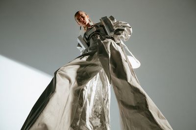 Low-Angle Fashion Model Strikes a Dominant Pose in Studio Void
