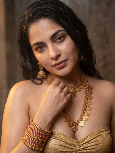 A beautiful Indian woman with wet skin stares confidently