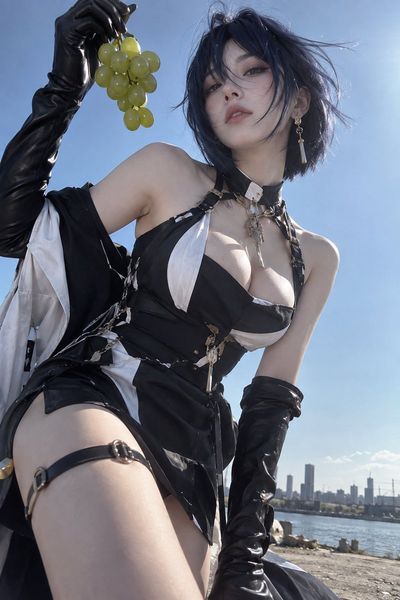 Low-angle shot captures model holding grapes against vast blue sky