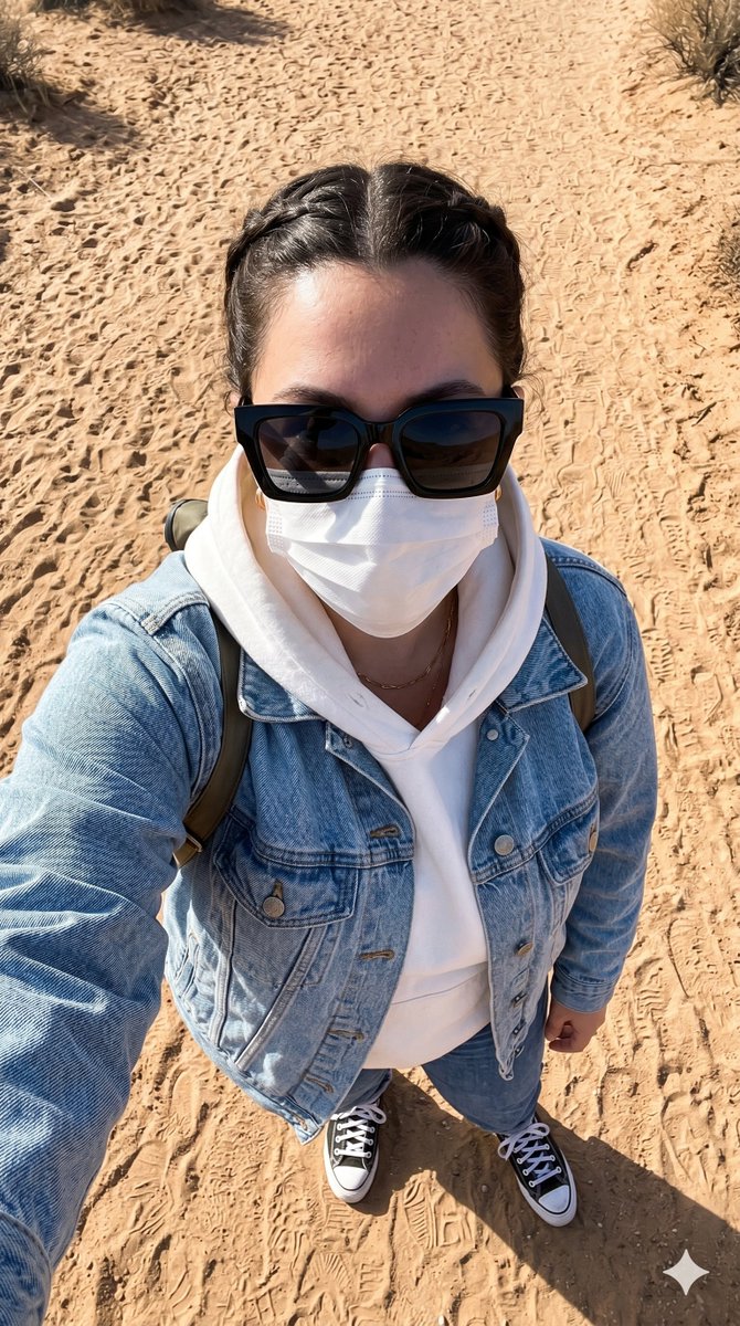 A young traveler takes an overhead selfie on a desert trail