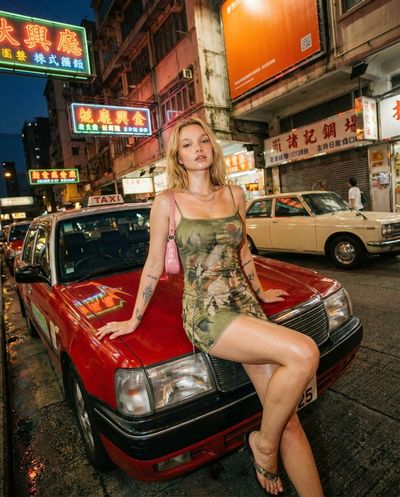 Neon Nights: A Bold Portrait on the Urban Taxi Hood