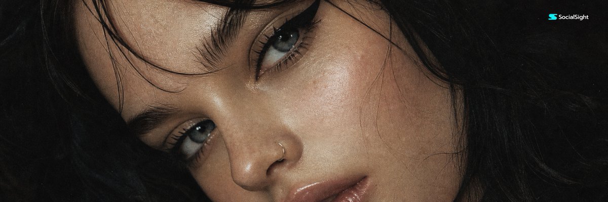 A close-up portrait with dramatic eyeliner and glossy lips