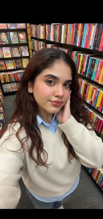 Serene Reader Amidst Vibrant Bookshelves