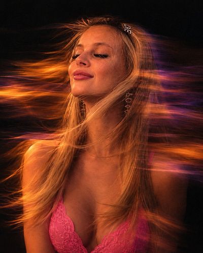 Cinematic Portrait Captures Motion Blur With Amber Violet Streaks