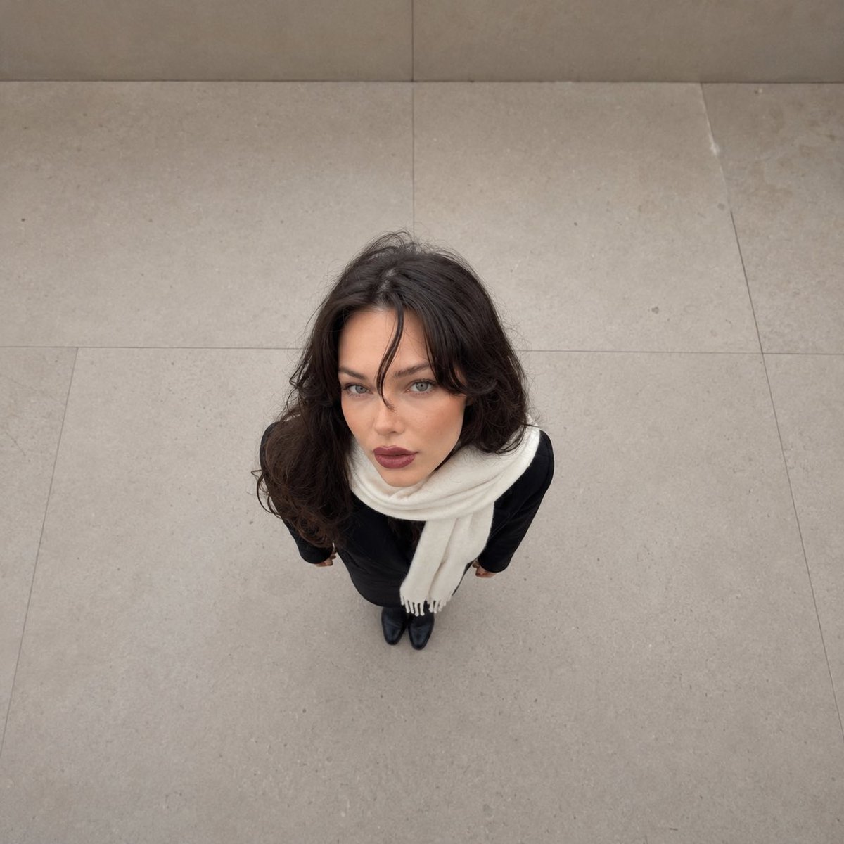 Overhead forced-perspective portrait shows giant head on tiny body