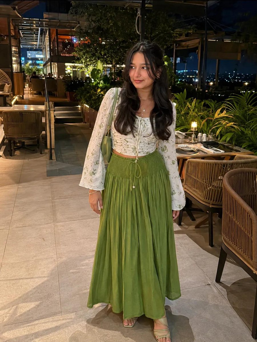 White floral crop top pairs with olive green maxi skirt