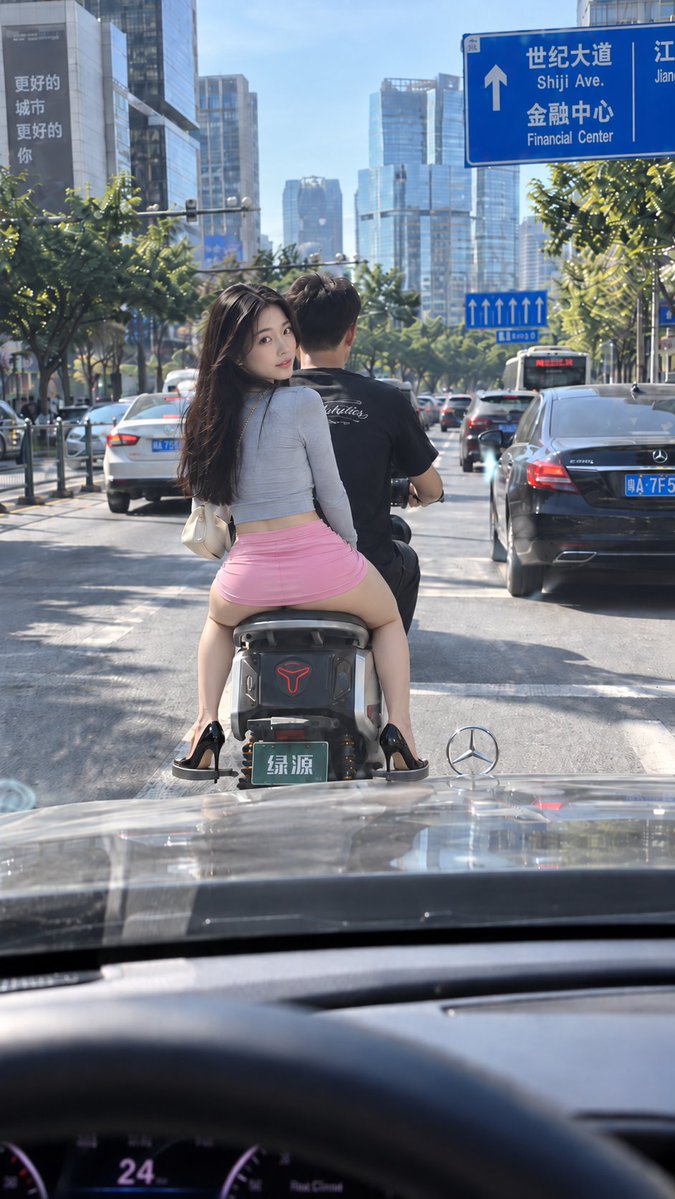 Young Woman Turns Back on Scooter in Busy City Traffic