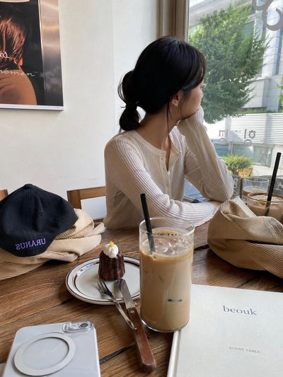 A cute Korean character enjoys a quiet coffee moment