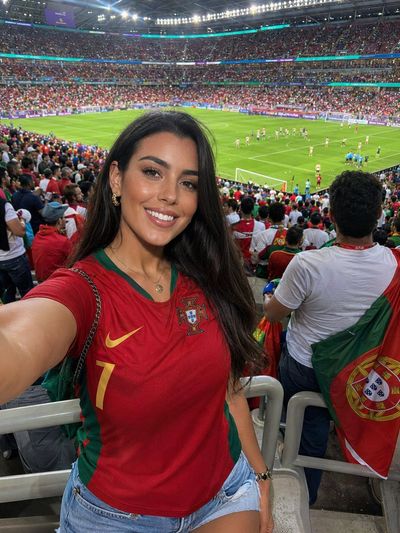 A Portuguese fan captures her selfie inside a packed stadium