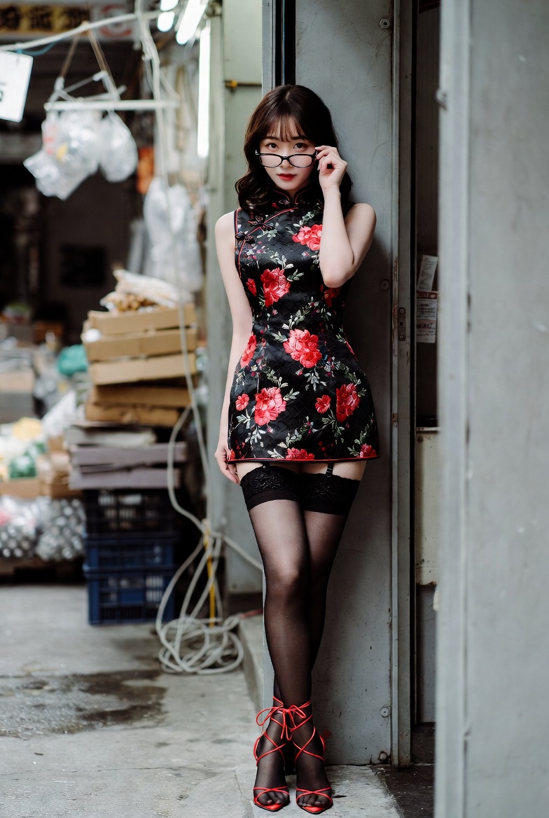 Woman in black cheongsam leans near neon grocery sign
