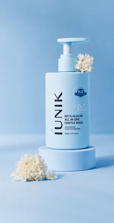 A single baby-blue pump bottle stands on a pedestal with flowers