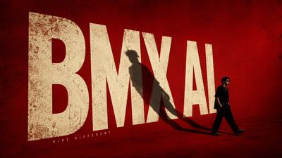 A young rebel walks past giant BMX AI letters on a red wall