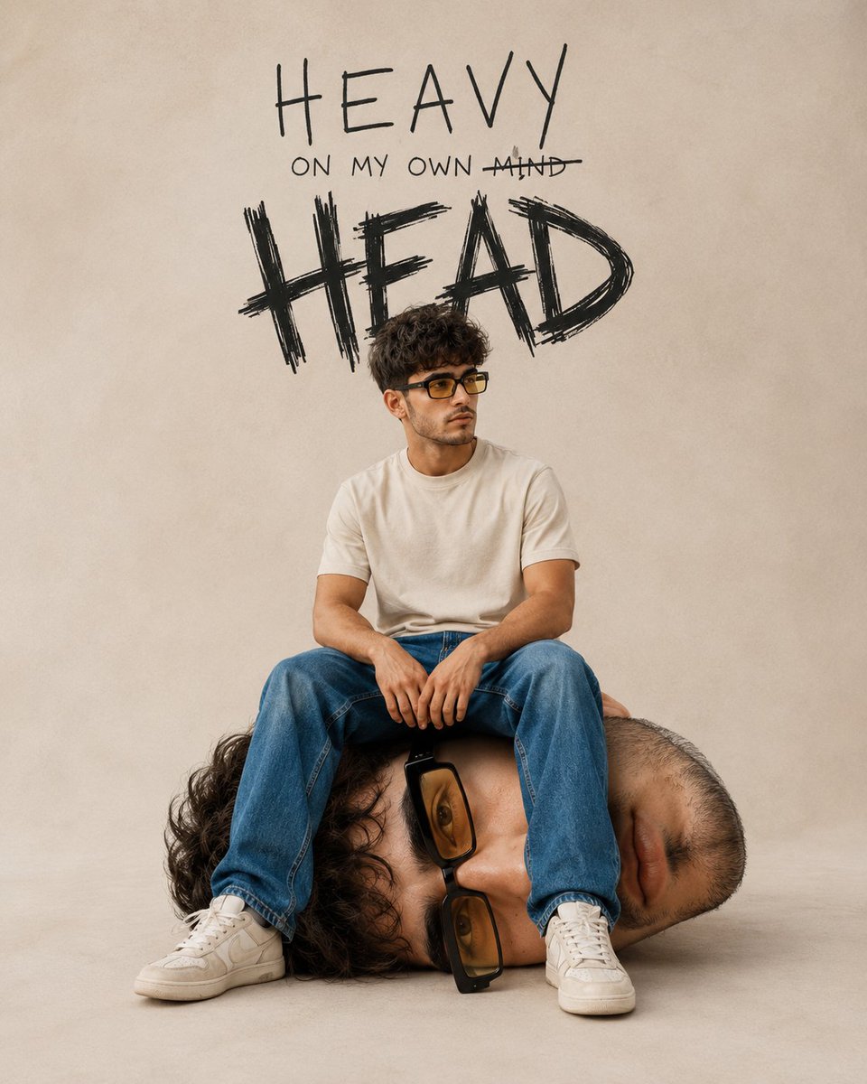 Young man sits on his own giant head in surreal portrait