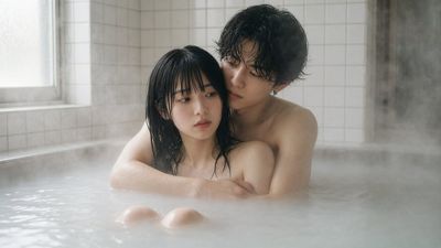 Young couple embraces in milky bath as steam swirls softly