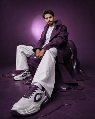 A low-angle shot emphasizes the forward sneaker in an editorial