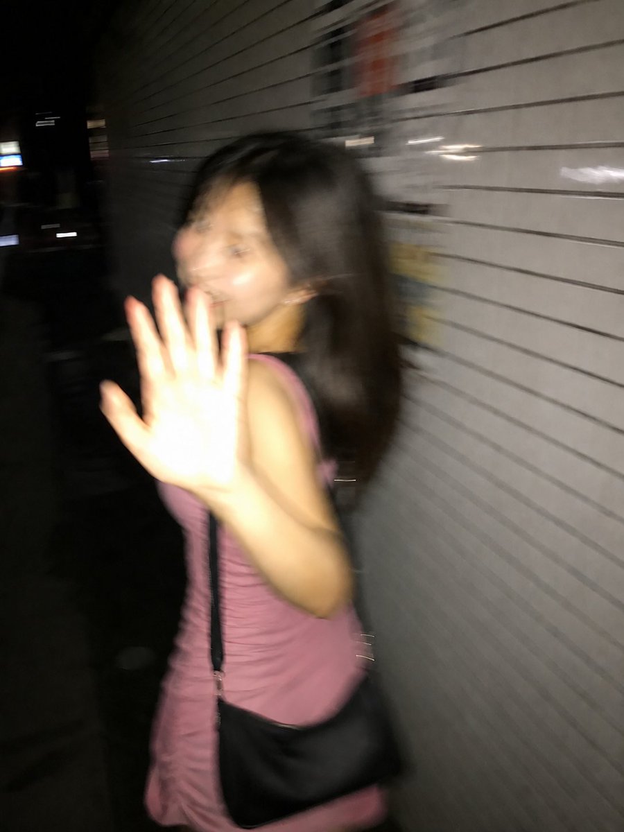 A surprised woman turns back mid-stride on a Tokyo sidewalk