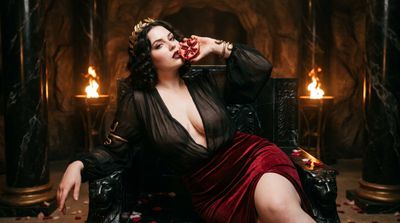 Persephone Reclines on Obsidian Throne Holding Pomegranate in Underworld