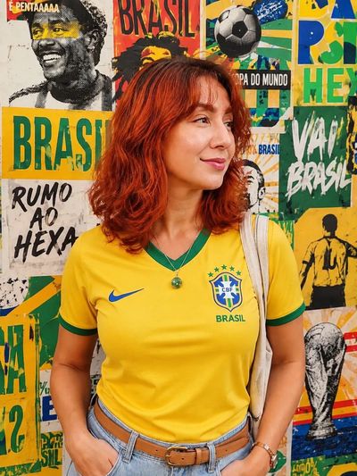 Brazilian fan poses confidently in vibrant street portrait