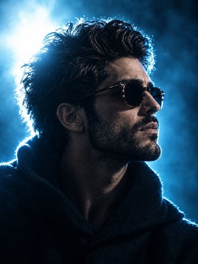 Cinematic Portrait of a Man in Cyan Backlight With Sunglasses