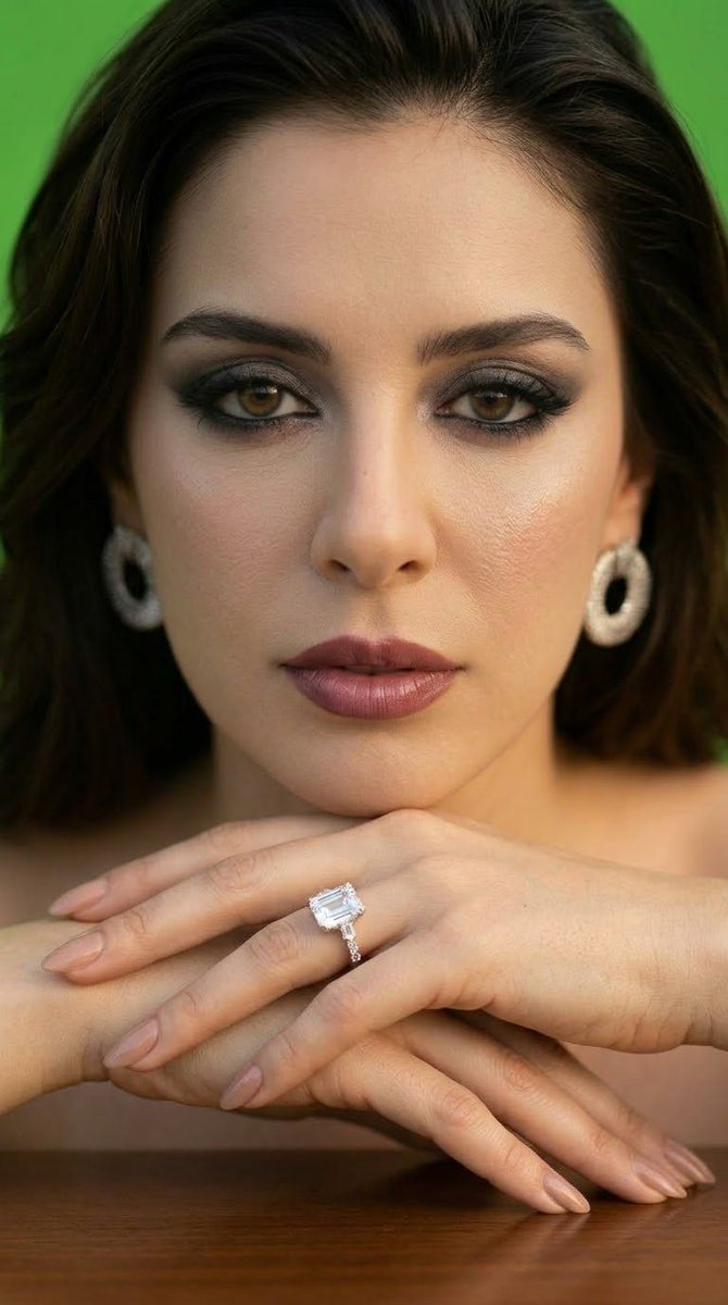Stunning Woman Wearing Emerald Diamond Ring in Studio Portrait