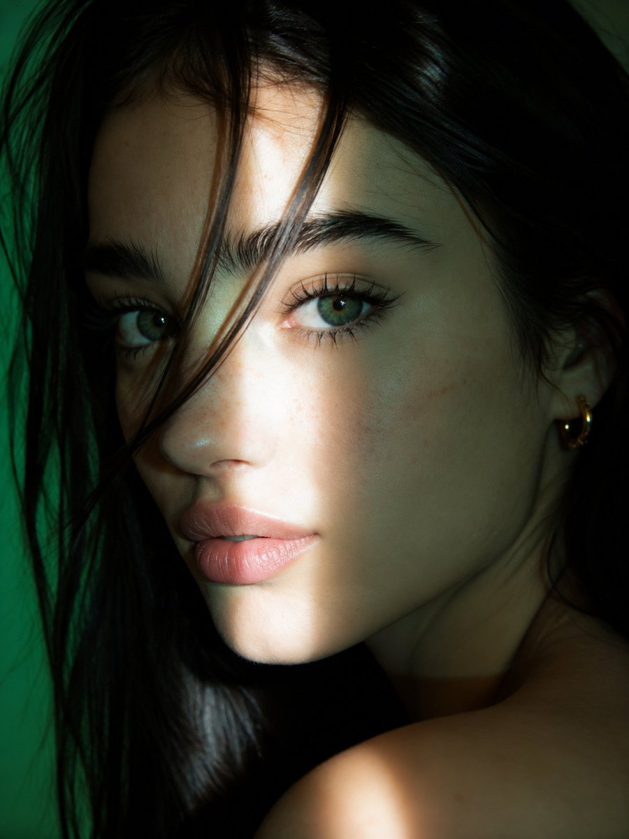 Emerald gaze meets warm sunlight in moody editorial portrait