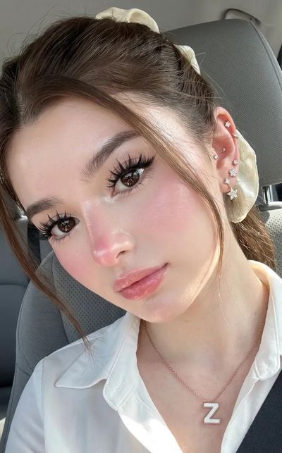 A woman takes a selfie in a car with natural light