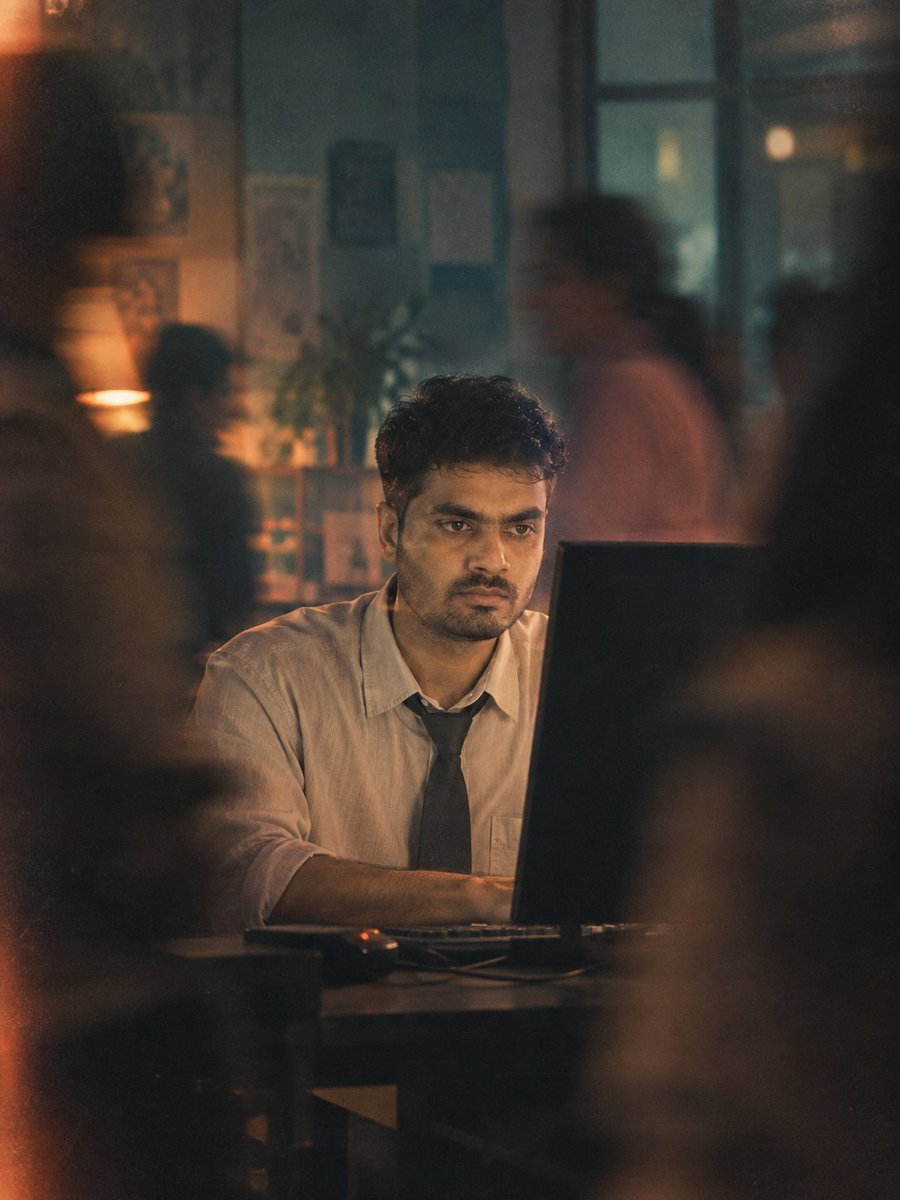 Man Lost in Work While Blurred Figures Pass By