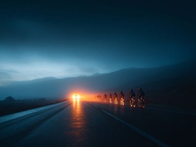 Solitary Vehicle Breaking Dawn on Misty Mountain Road
