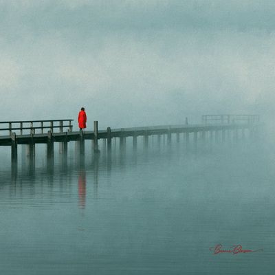 A lone woman in red walks into thick morning fog on a wooden pier