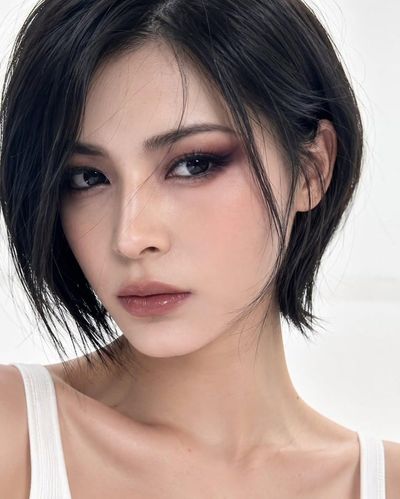 Elegant Korean-inspired short bob shines under soft studio lighting.
