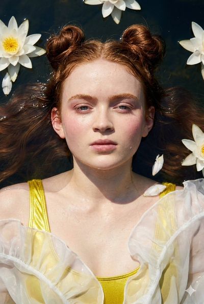 Sadie Sink floats serenely on dark lake water