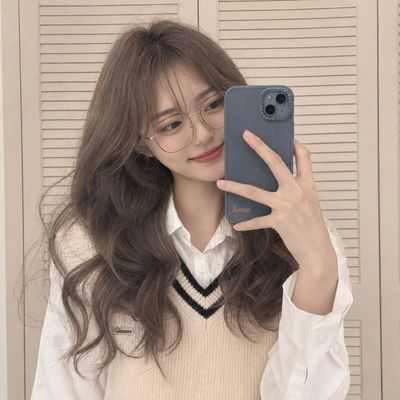 A mirror selfie with a phone partially hiding the face creates a candid mood
