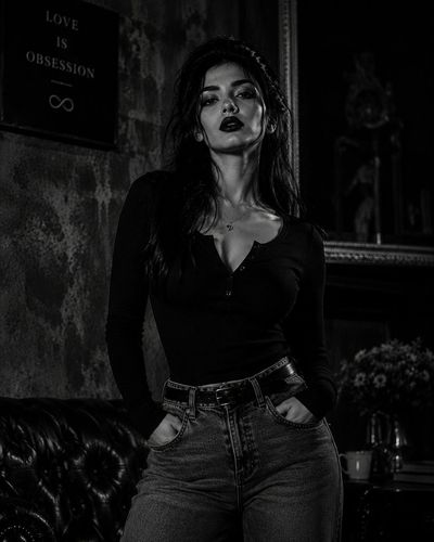 A confident queen in black leather commands the urban night