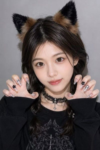 A cute cat-eared girl strikes a playful claw pose