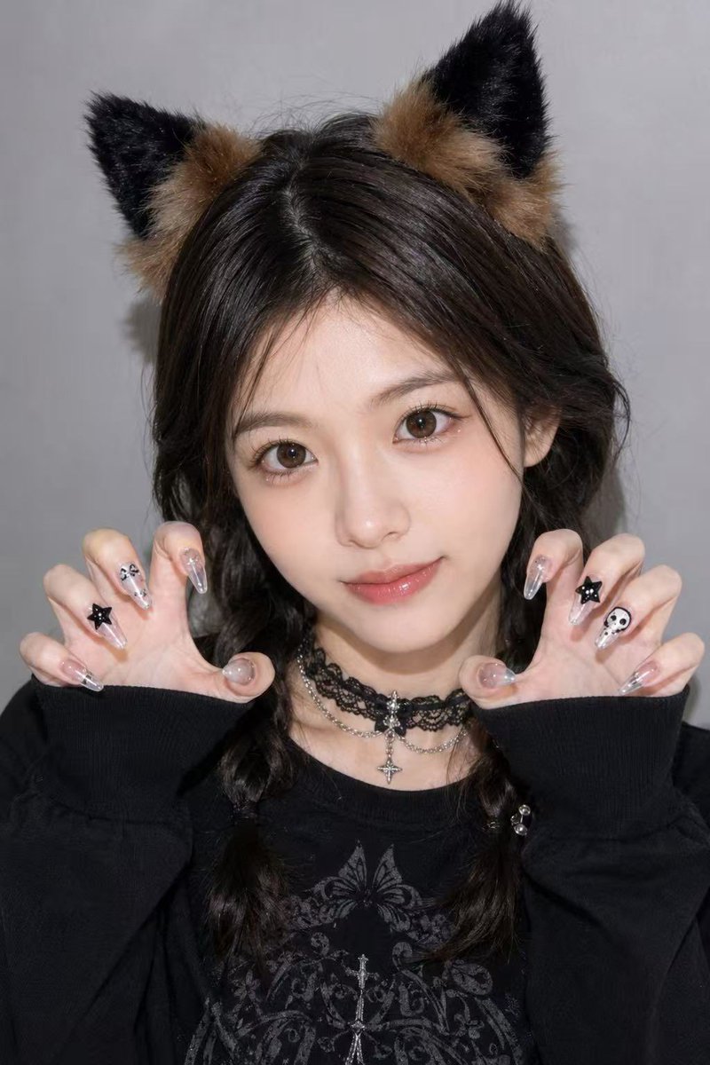 A cute cat-eared girl strikes a playful claw pose