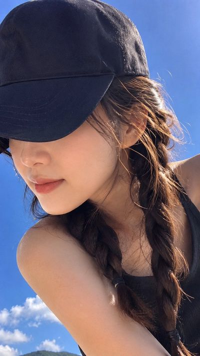 A side profile portrait with baseball cap in summer sunlight