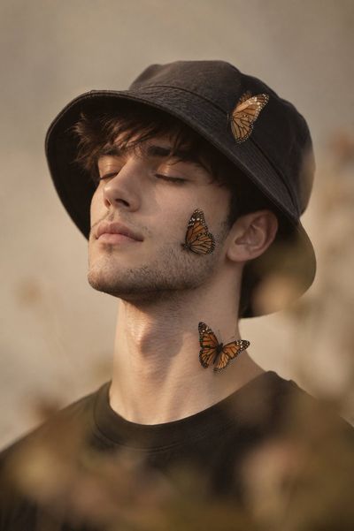 A serene side profile portrait with closed eyes and butterflies