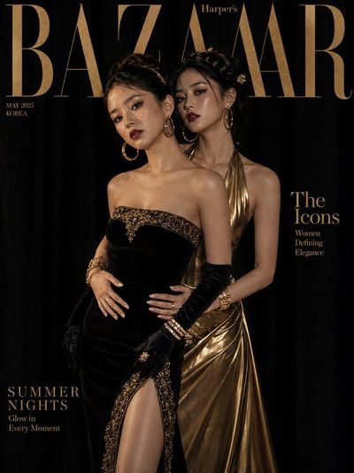 Two Korean models pose in black and gold gowns on velvet studio
