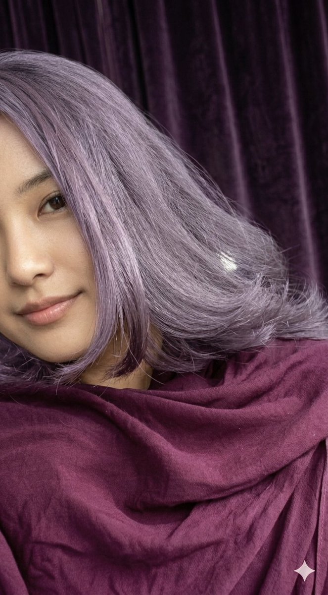 Woman with lavender hair smiles softly in purple velvet light