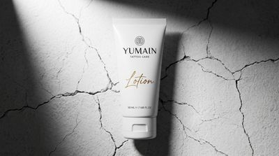 Elegant Teal Hand Cream Tube on Soft Beige Fabric