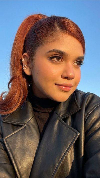 Golden Hour Glow on Confident Woman in Leather Jacket