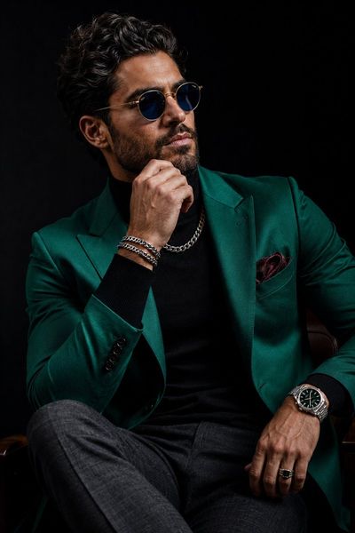 Emerald blazer and confident pose define modern luxury style