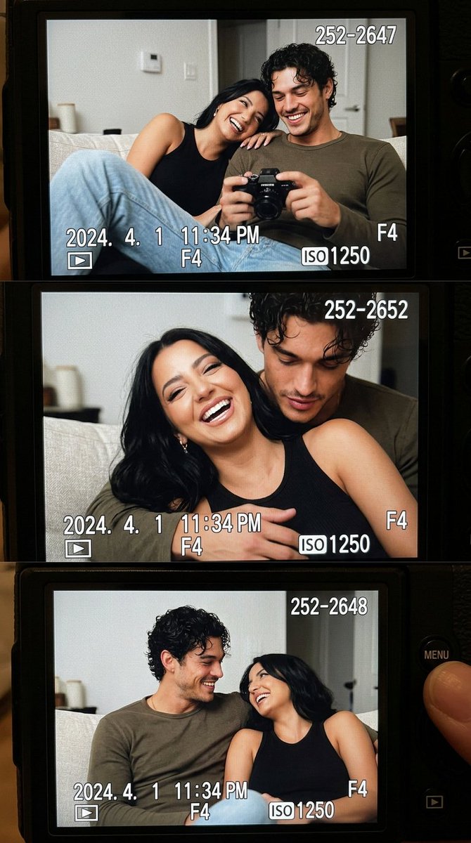 Young couple laughing on sofa captured through digital camera LCD
